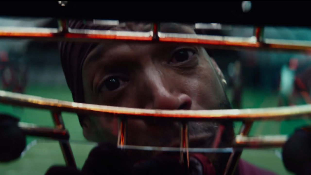 A teary Marlon Wayans looks through a football helmet in Him.