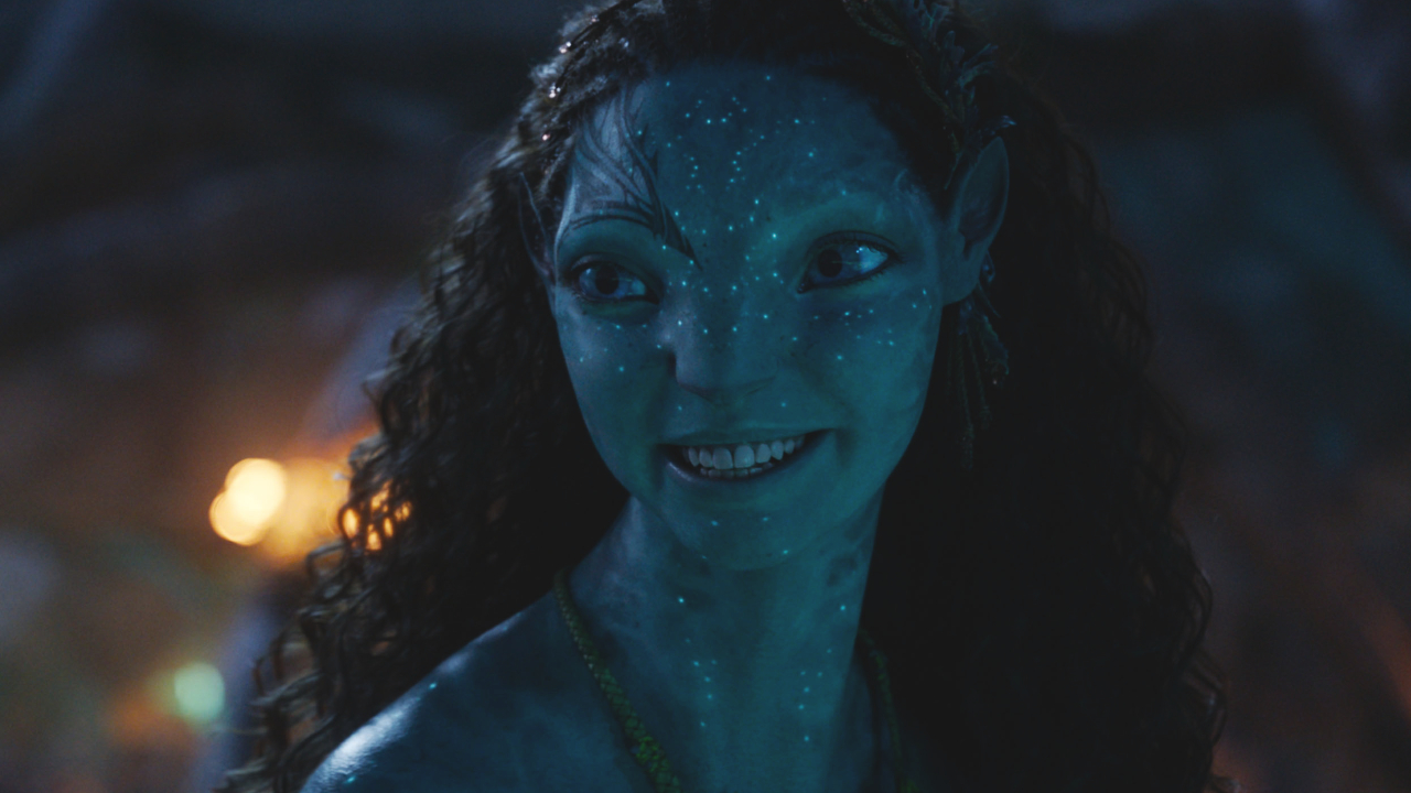 Tsireya smiles in a night time scene in Avatar: Fire and Ash. 