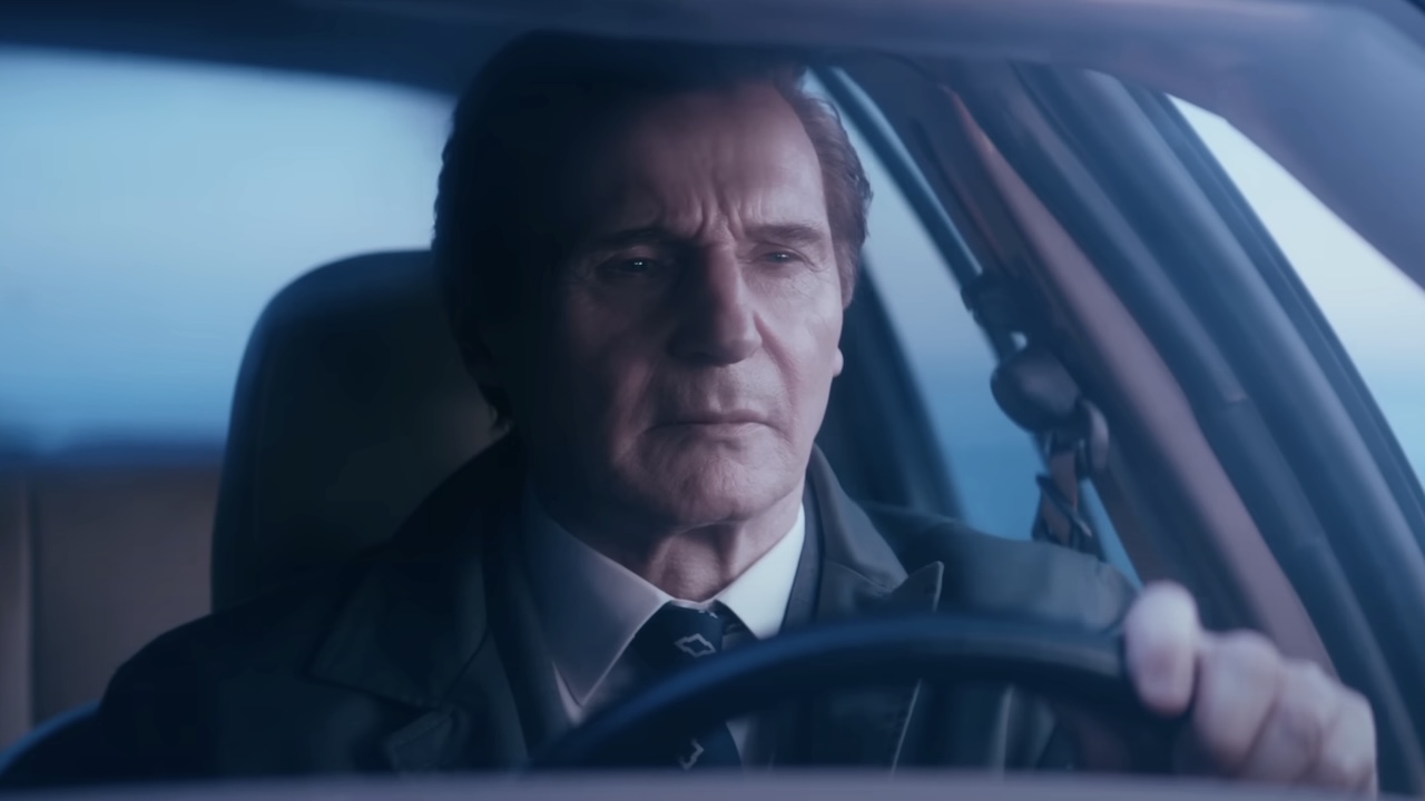 Liam Neeson&#039;s Frank Drebin Jr. driving in The Naked Gun