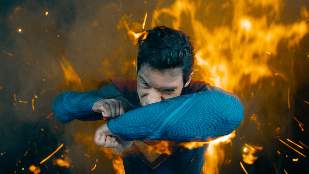 Superman (David Corenswet) shileding himself from fire in Superman